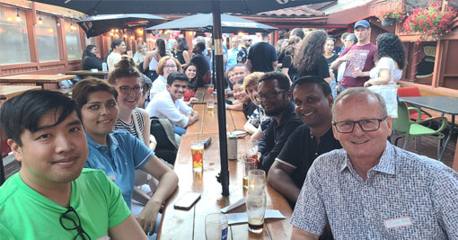 A group of people practicing French conversation in a relaxed Toronto social setting.